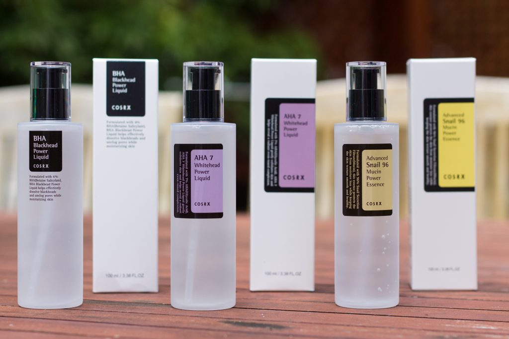 The lineup: BHA Blackhead Power Liquid, AHA Whitehead Power Liquid, and Advanced Snail 96 Mucin Power Essence in their black, purple and yellow packaging.